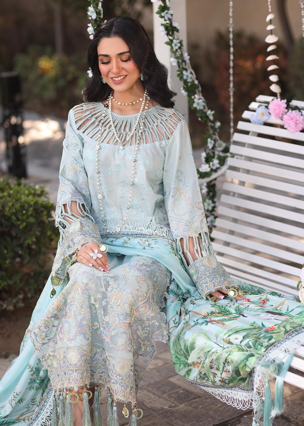 Model wearing pastel blue embroidered dress with tassel detailing from Musferah Saad's Selene, Pakistani luxury pret available online in UK.