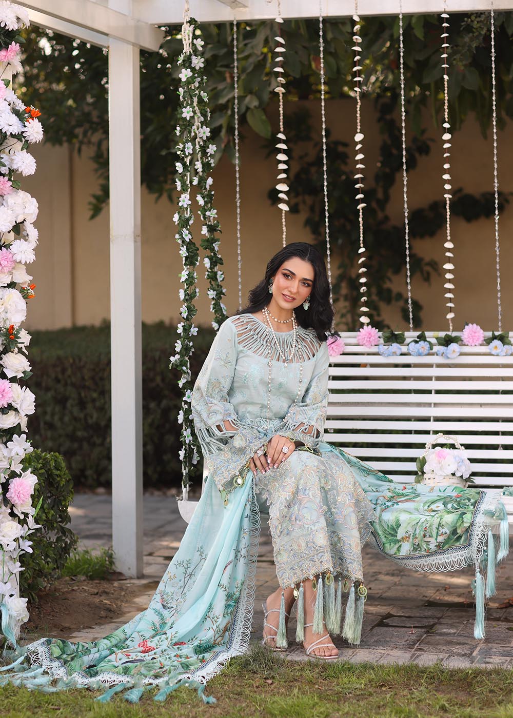 Model wearing pastel blue embroidered dress with tassel detailing from Musferah Saad's Selene, Pakistani luxury pret available online in UK.