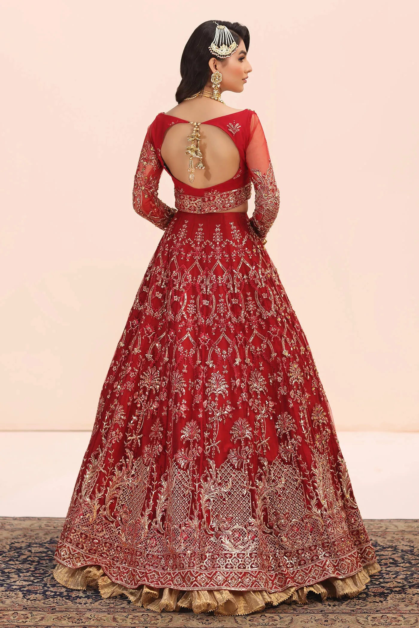 Model in Musferah Saad Crimson Jewel red Pakistani wedding dress, UK.