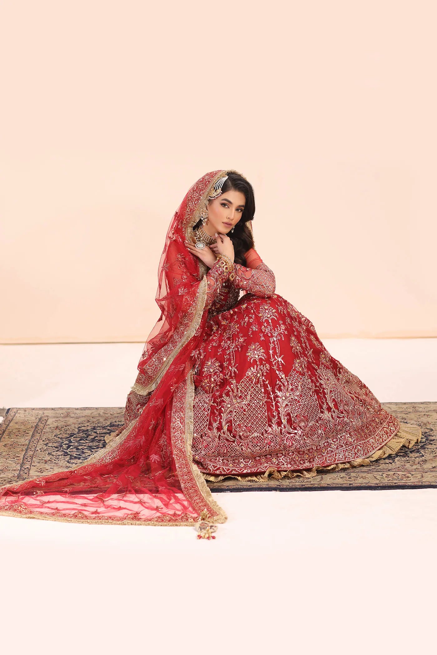 Model in Musferah Saad Crimson Jewel red Pakistani wedding dress, UK.