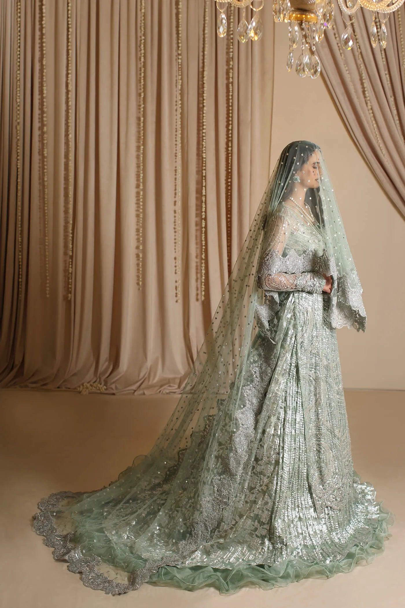 Model wearing Musferah Saad Aqua Grandeur, an exquisite Pakistani bridal dress in UK.