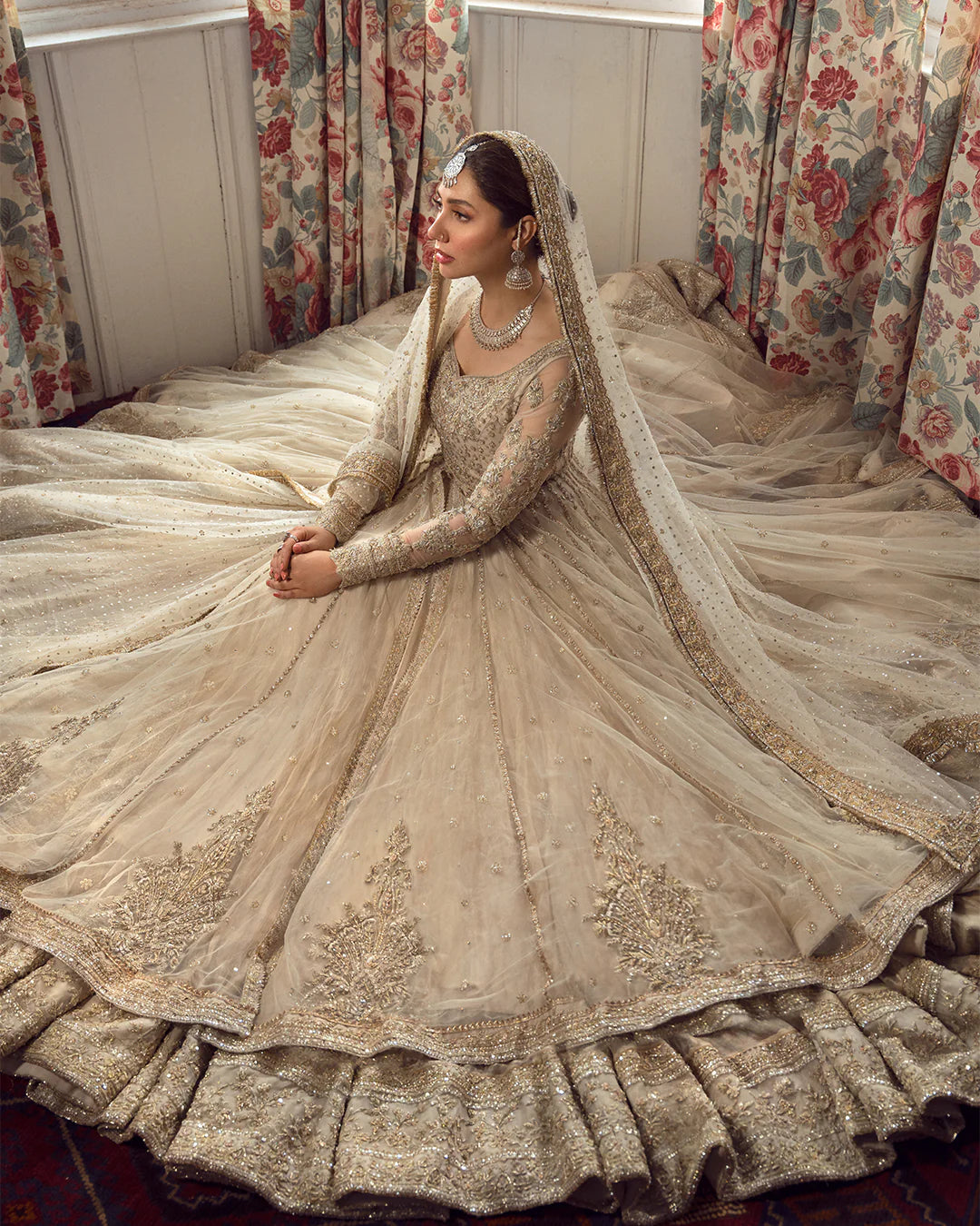Model wearing Faiza Saqlain Anamta dress in ivory, adorned with delicate embellishments, perfect for Pakistani nikkah bridal wear available online in the UK.