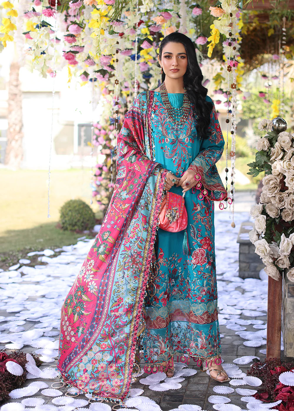 Model wearing teal and pink floral embroidered dress from Musferah Saad Pretty Girls Luxury Lawn 2025 Celestia. Pakistani clothes online UK.