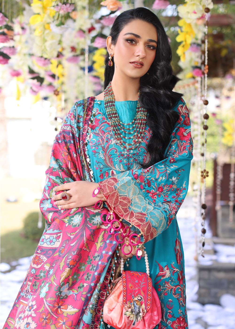 Model wearing teal and pink floral embroidered dress from Musferah Saad Pretty Girls Luxury Lawn 2025 Celestia. Pakistani clothes online UK.