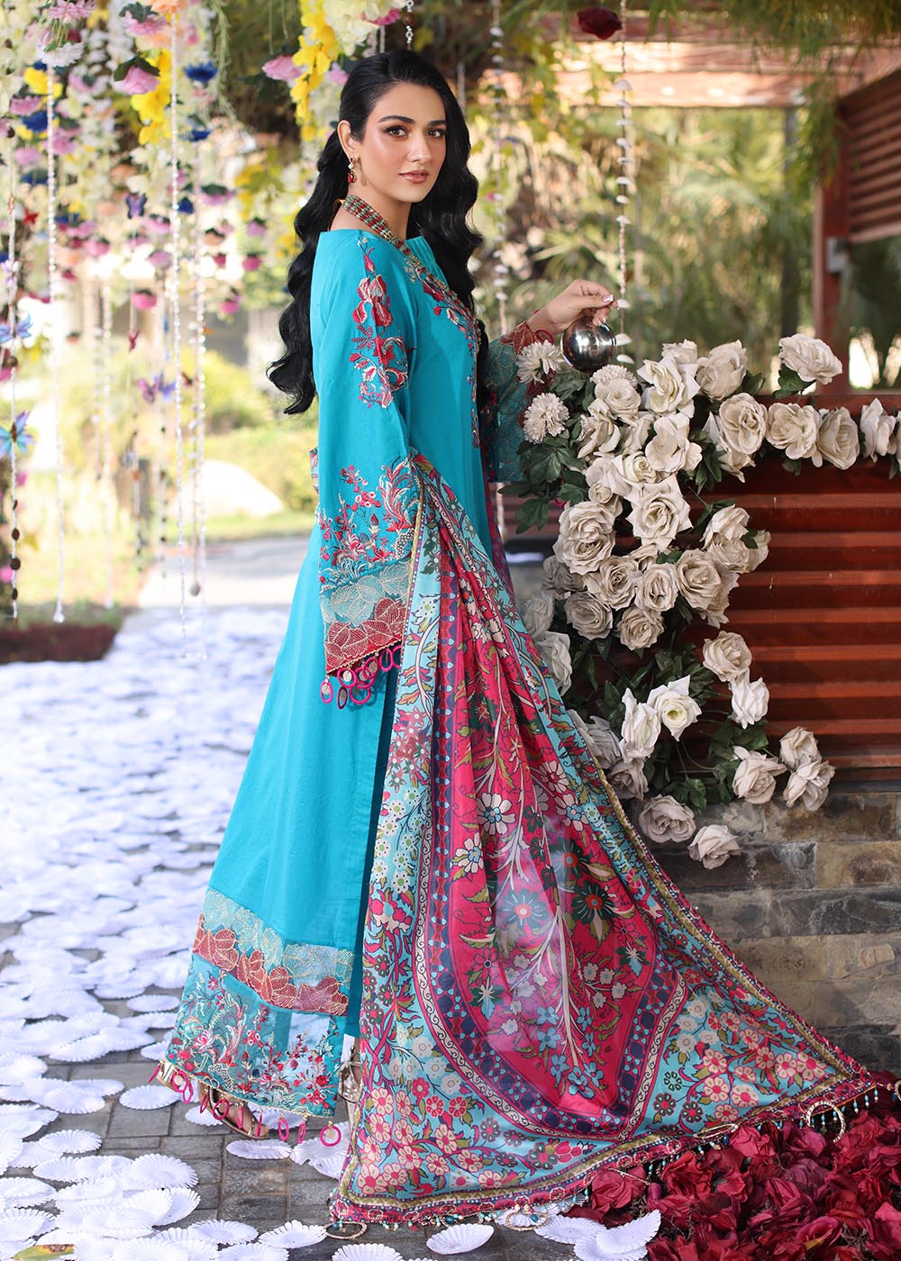 Model wearing teal and pink floral embroidered dress from Musferah Saad Pretty Girls Luxury Lawn 2025 Celestia. Pakistani clothes online UK.