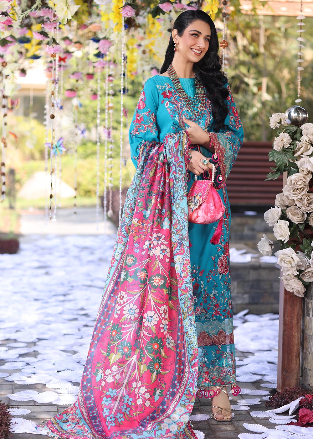 Model wearing teal and pink floral embroidered dress from Musferah Saad Pretty Girls Luxury Lawn 2025 Celestia. Pakistani clothes online UK.