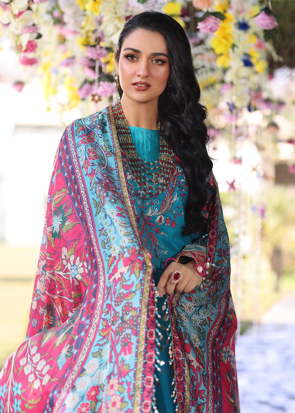 Model wearing teal and pink floral embroidered dress from Musferah Saad Pretty Girls Luxury Lawn 2025 Celestia. Pakistani clothes online UK.