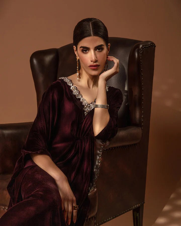 Model wearing a burgundy Adiba dress from Faiza Saqlain's Aleira Evening Edit '24 collection. Pakistani clothes online in UK.