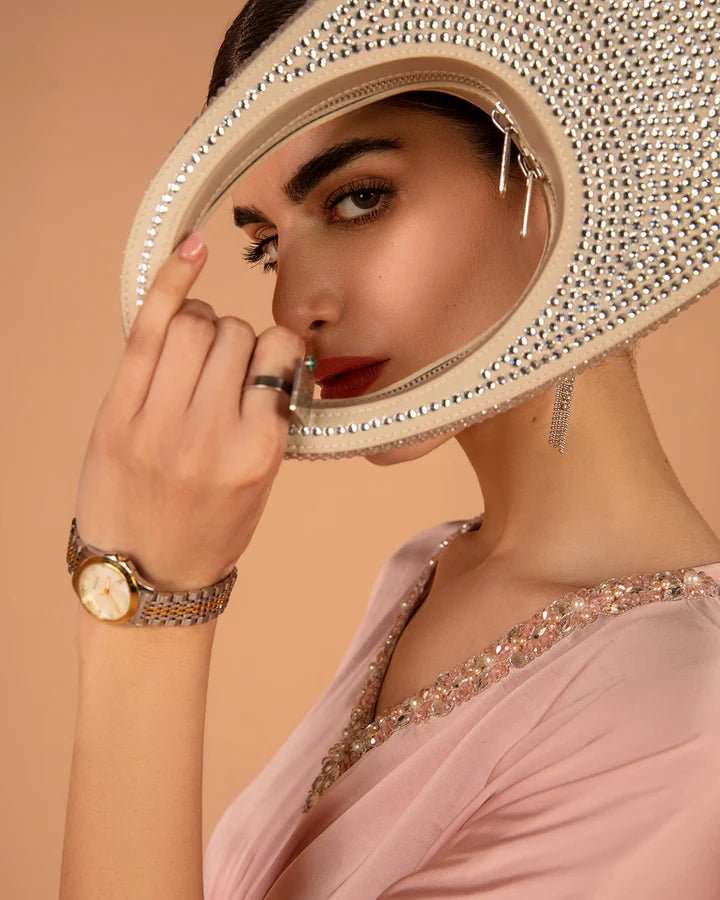 Model wearing a pink Derifa dress from Faiza Saqlain's Aleira Evening Edit '24 collection. Pakistani clothes online in UK.