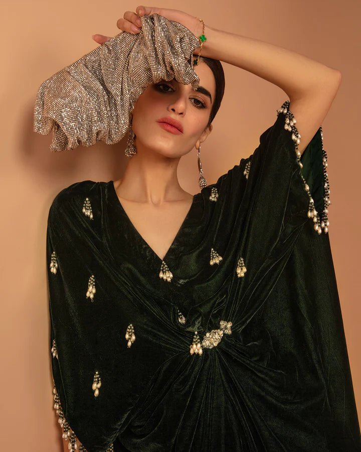 Model wearing a green Perin dress from Faiza Saqlain's Aleira Evening Edit '24 collection. Pakistani clothes online in UK.