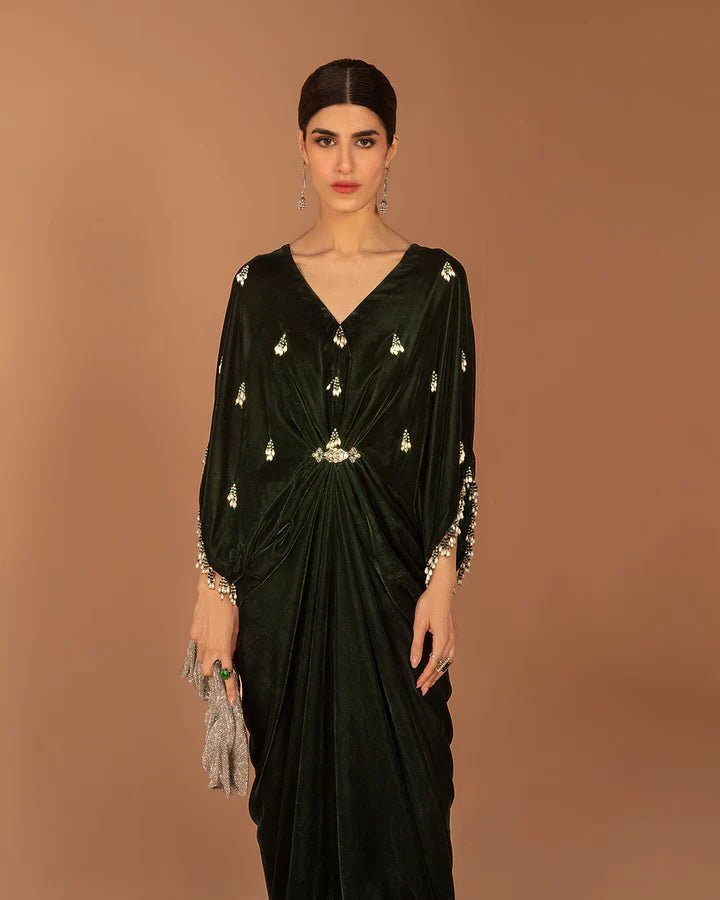 Model wearing a green Perin dress from Faiza Saqlain's Aleira Evening Edit '24 collection. Pakistani clothes online in UK.