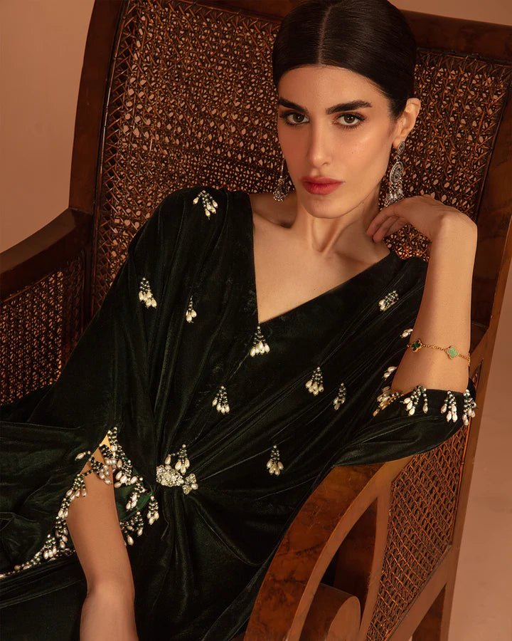 Model wearing a green Perin dress from Faiza Saqlain's Aleira Evening Edit '24 collection. Pakistani clothes online in UK.