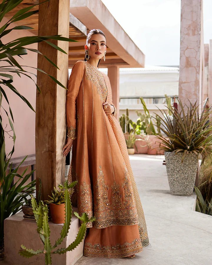 Model wearing a rust - colored Dalisay dress from Faiza Saqlain's Lenora Luxury Pret '24 collection. Pakistani clothes online in UK.