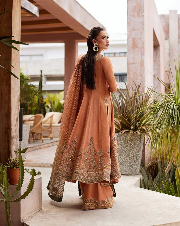 Model wearing a rust - colored Dalisay dress from Faiza Saqlain's Lenora Luxury Pret '24 collection. Pakistani clothes online in UK.