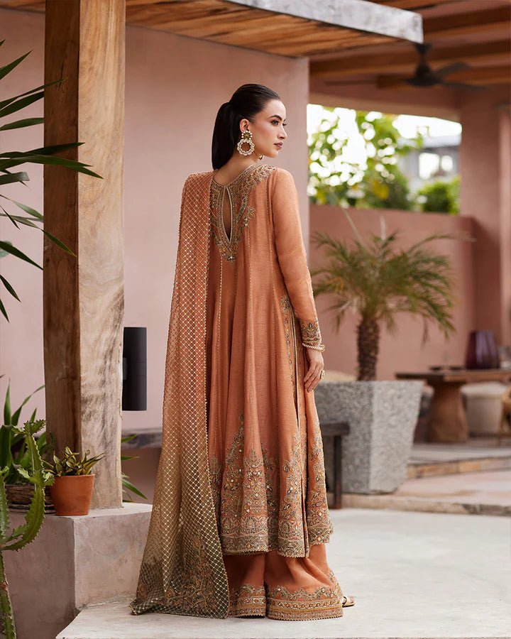 Model wearing a rust - colored Dalisay dress from Faiza Saqlain's Lenora Luxury Pret '24 collection. Pakistani clothes online in UK.