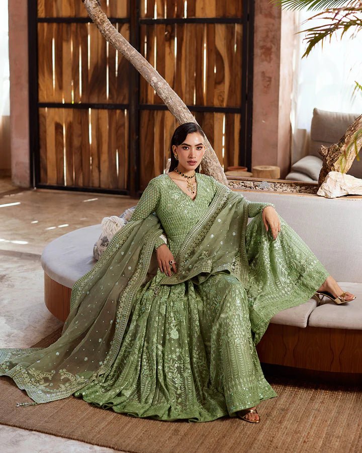 Model wearing a green Eiraam dress from Faiza Saqlain's Lenora Luxury Pret '24 collection. Pakistani clothes online in UK.