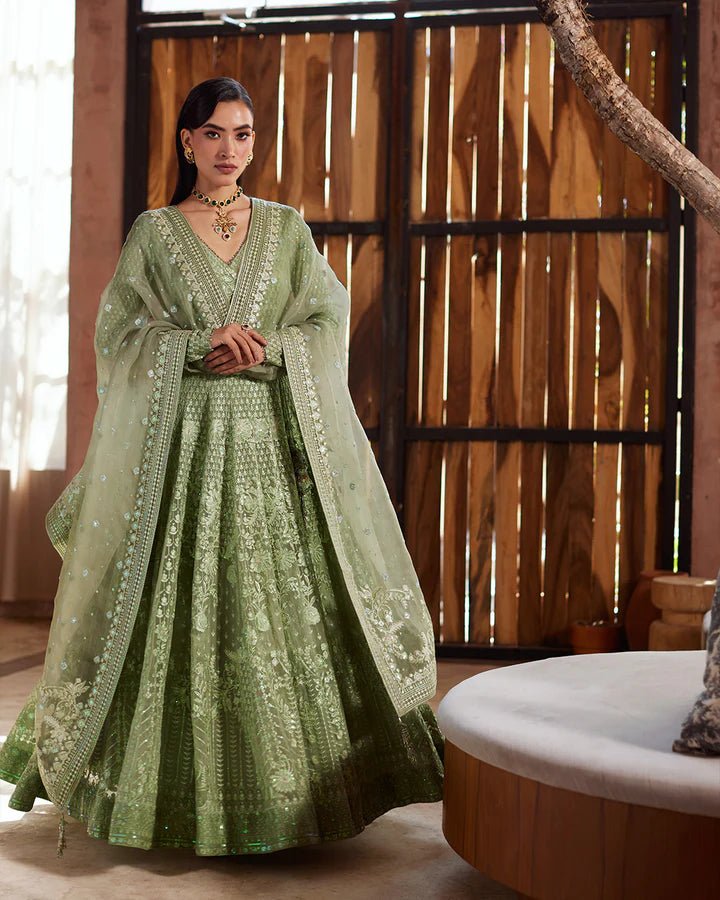 Model wearing a green Eiraam dress from Faiza Saqlain's Lenora Luxury Pret '24 collection. Pakistani clothes online in UK.