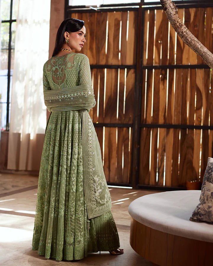 Model wearing a green Eiraam dress from Faiza Saqlain's Lenora Luxury Pret '24 collection. Pakistani clothes online in UK.