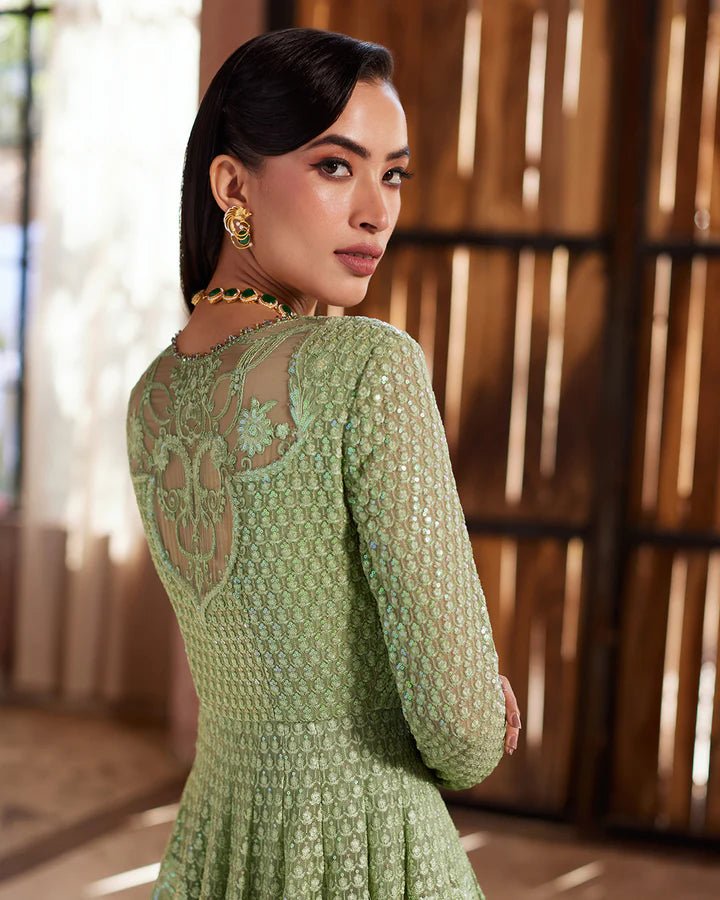 Model wearing a green Eiraam dress from Faiza Saqlain's Lenora Luxury Pret '24 collection. Pakistani clothes online in UK.