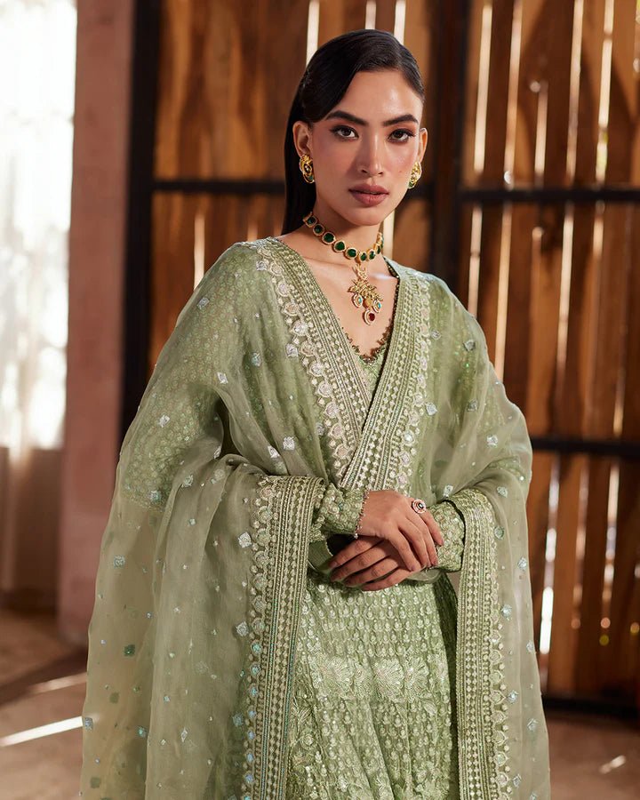 Model wearing a green Eiraam dress from Faiza Saqlain's Lenora Luxury Pret '24 collection. Pakistani clothes online in UK.