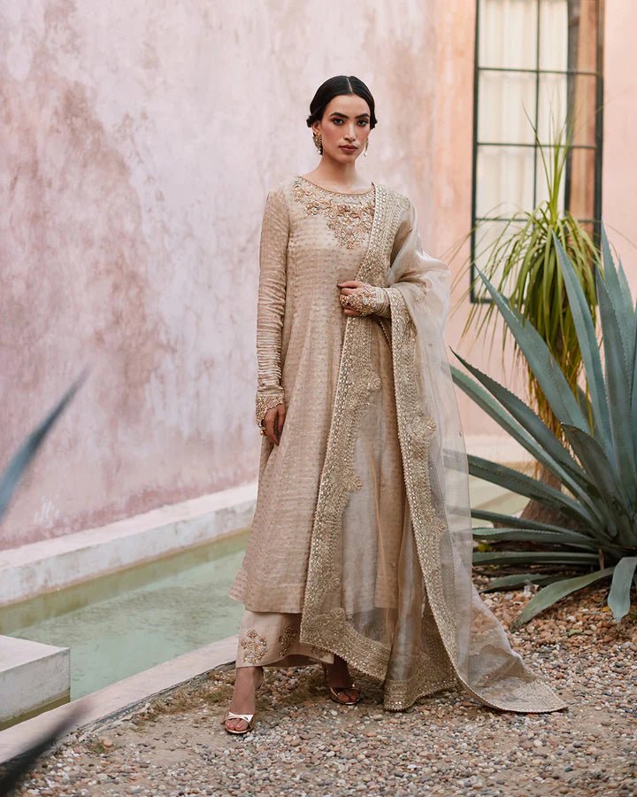 Model wearing a beige Moira dress from Faiza Saqlain's Lenora Luxury Pret '24 collection. Pakistani clothes online in UK.