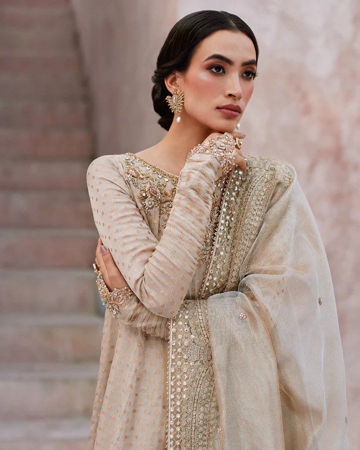Model wearing a beige Moira dress from Faiza Saqlain's Lenora Luxury Pret '24 collection. Pakistani clothes online in UK.