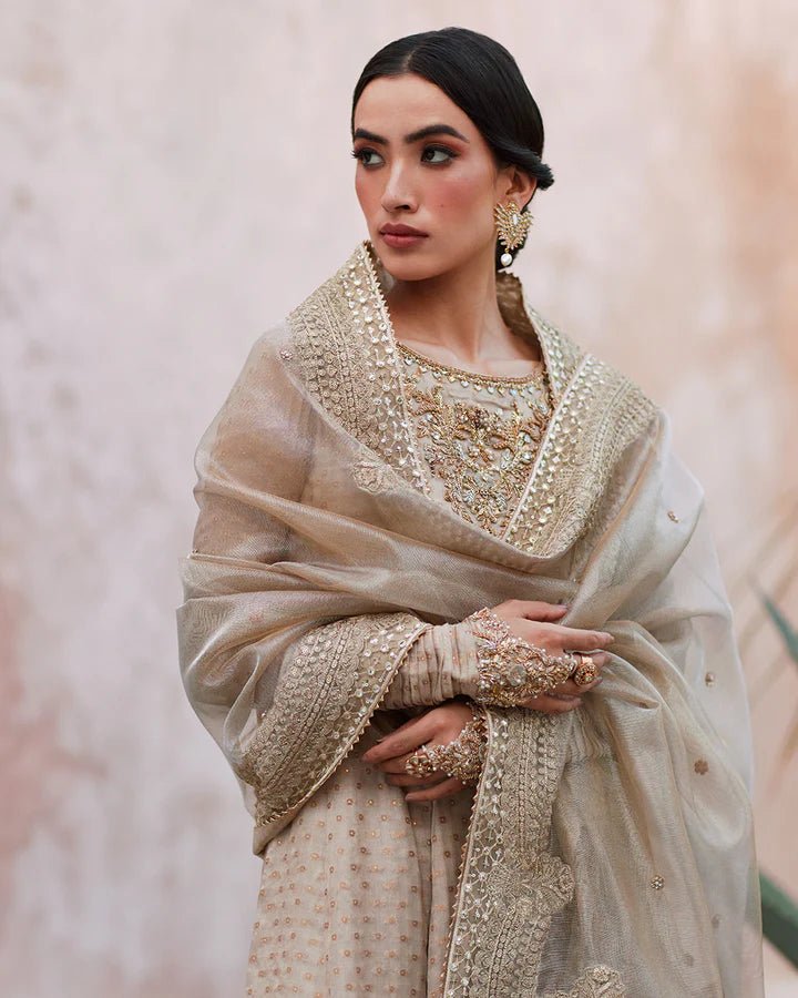 Model wearing a beige Moira dress from Faiza Saqlain's Lenora Luxury Pret '24 collection. Pakistani clothes online in UK.