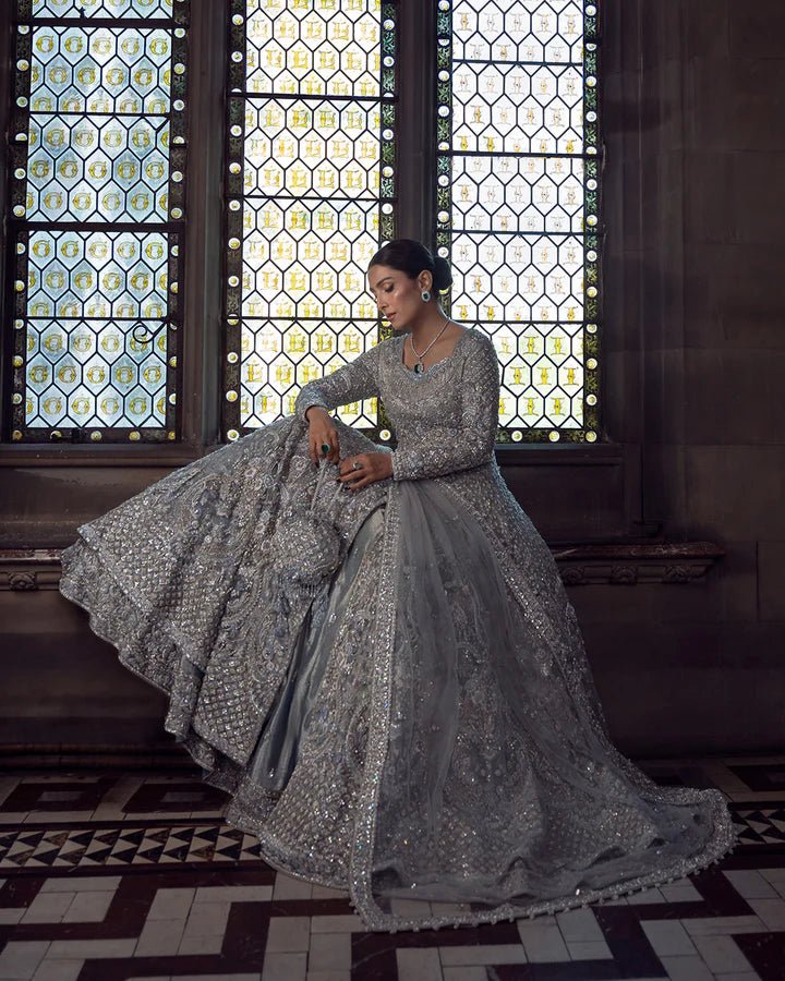 Model wearing a silver Ayana bridal dress by Faiza Saqlain with intricate embellishments, ideal for Pakistani weddings, available online in the UK.