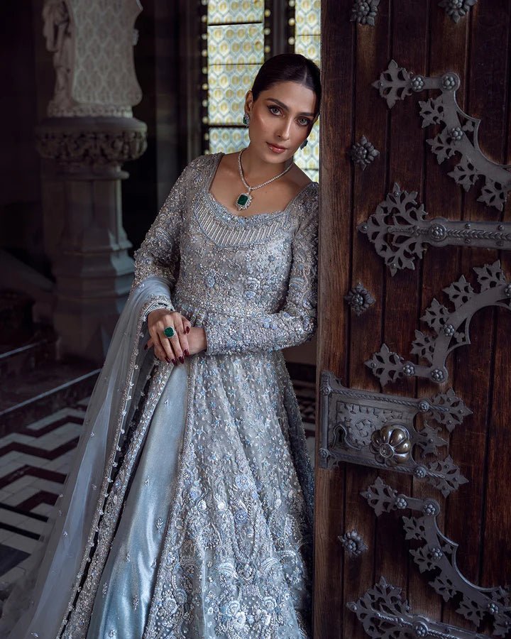 Model wearing a silver Ayana bridal dress by Faiza Saqlain with intricate embellishments, ideal for Pakistani weddings, available online in the UK.