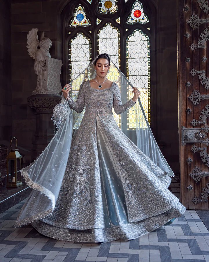 Model wearing a silver Ayana bridal dress by Faiza Saqlain with intricate embellishments, ideal for Pakistani weddings, available online in the UK.