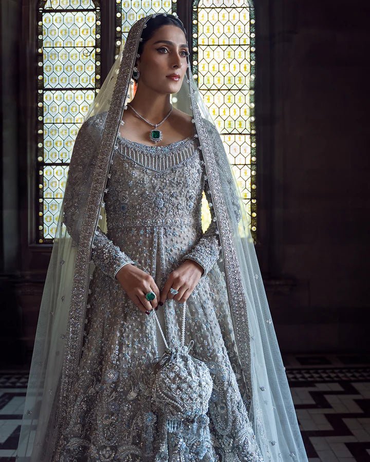 Model wearing a silver Ayana bridal dress by Faiza Saqlain with intricate embellishments, ideal for Pakistani weddings, available online in the UK.