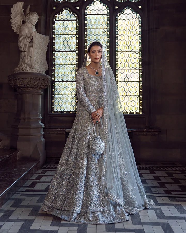 Model wearing a silver Ayana bridal dress by Faiza Saqlain with intricate embellishments, ideal for Pakistani weddings, available online in the UK.