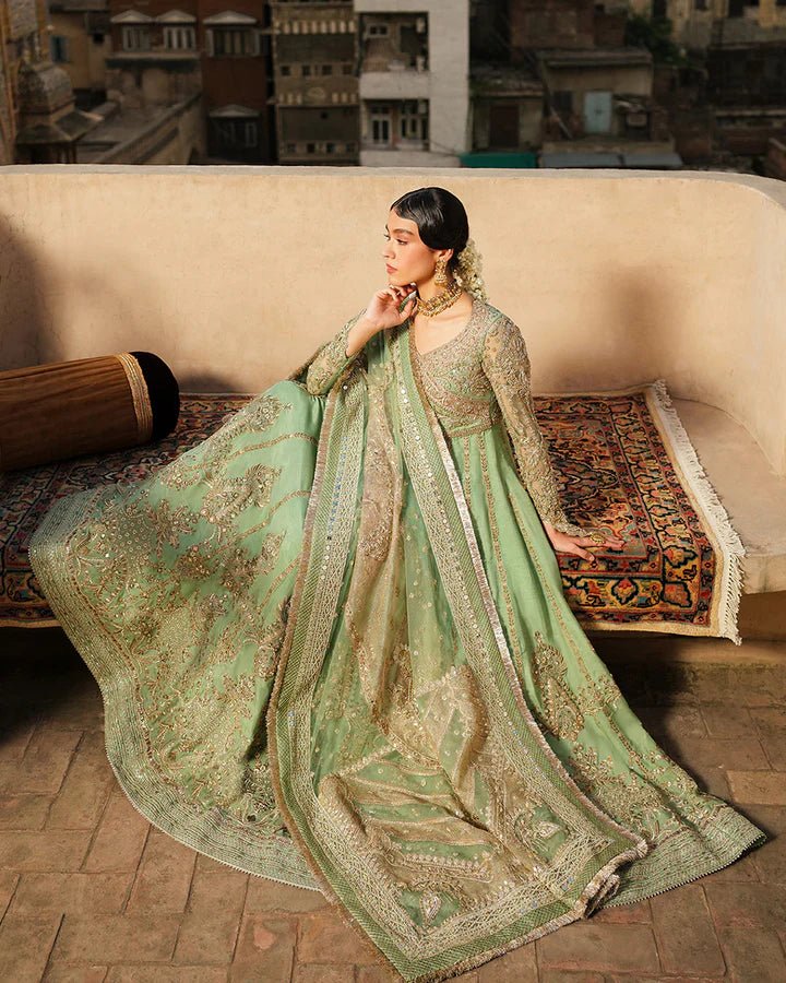 Model wearing Faiza Saqlain Formals Irina Oct '23 Adana dress in pistachio green, showingPakistani clothes online in UK.