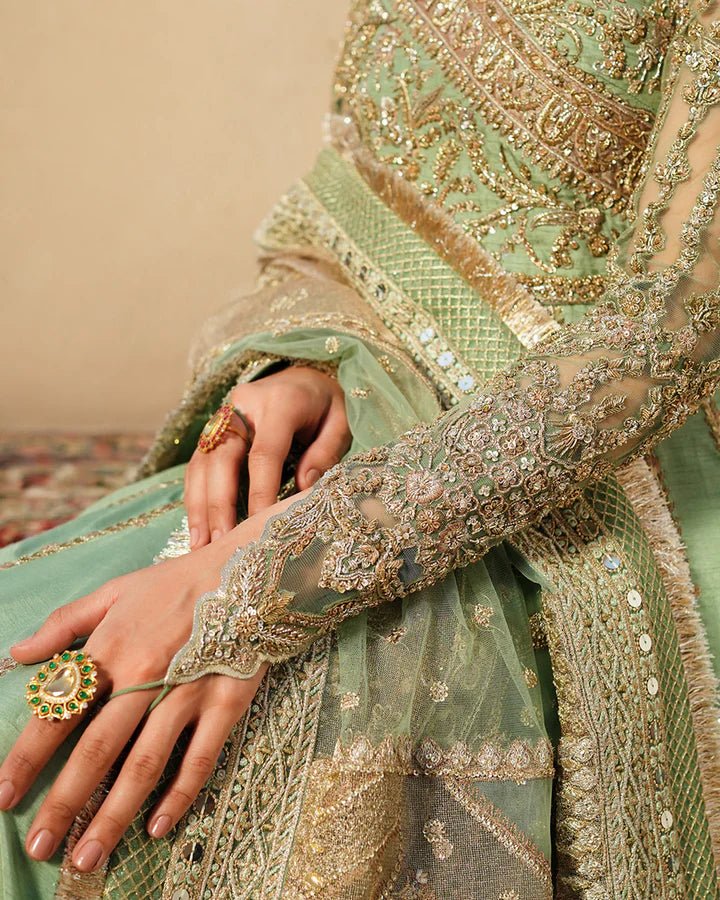 Model wearing Faiza Saqlain Formals Irina Oct '23 Adana dress in pistachio green, showingPakistani clothes online in UK.