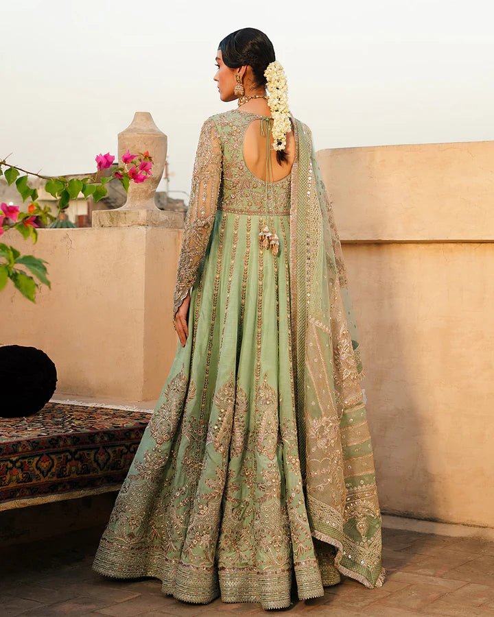 Model wearing Faiza Saqlain Formals Irina Oct '23 Adana dress in pistachio green, showingPakistani clothes online in UK.