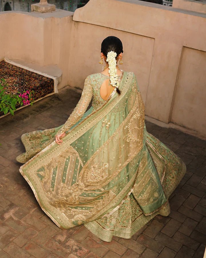 Model wearing Faiza Saqlain Formals Irina Oct '23 Adana dress in pistachio green, showingPakistani clothes online in UK.