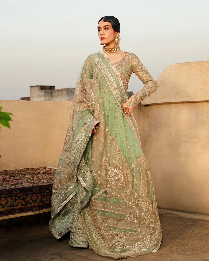 Model wearing Faiza Saqlain Formals Irina Oct '23 Adana dress in pistachio green, showingPakistani clothes online in UK.