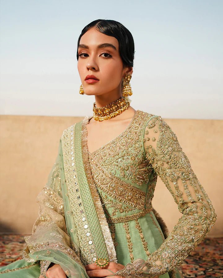 Model wearing Faiza Saqlain Formals Irina Oct '23 Adana dress in pistachio green, showingPakistani clothes online in UK.