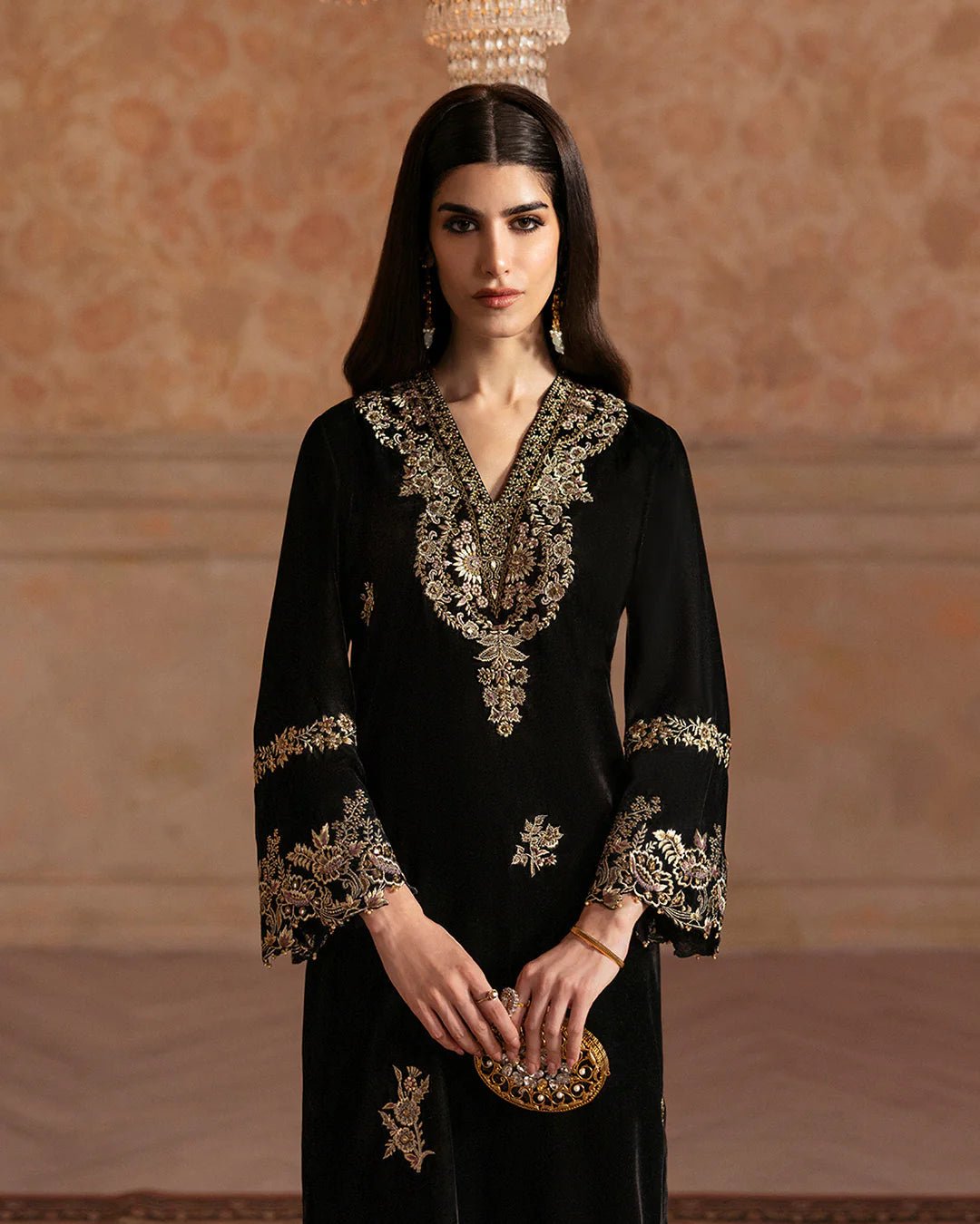 Model wearing Faiza Saqlain Ismene Velvet Vita dress in black with luxurious gold embroidery. Shop Pakistani bridal dresses online in the UK now.
