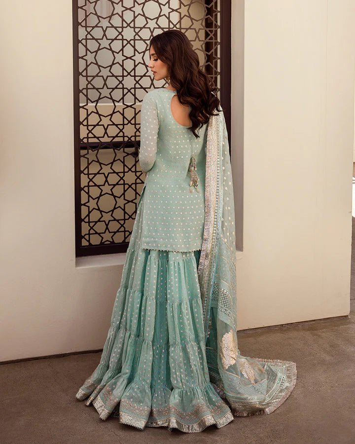 Model wearing a pastel blue Sefana dress with detailed embroidery from Faiza Saqlain's Aleira Evening Edit '24 collection. Pakistani clothes online in UK.