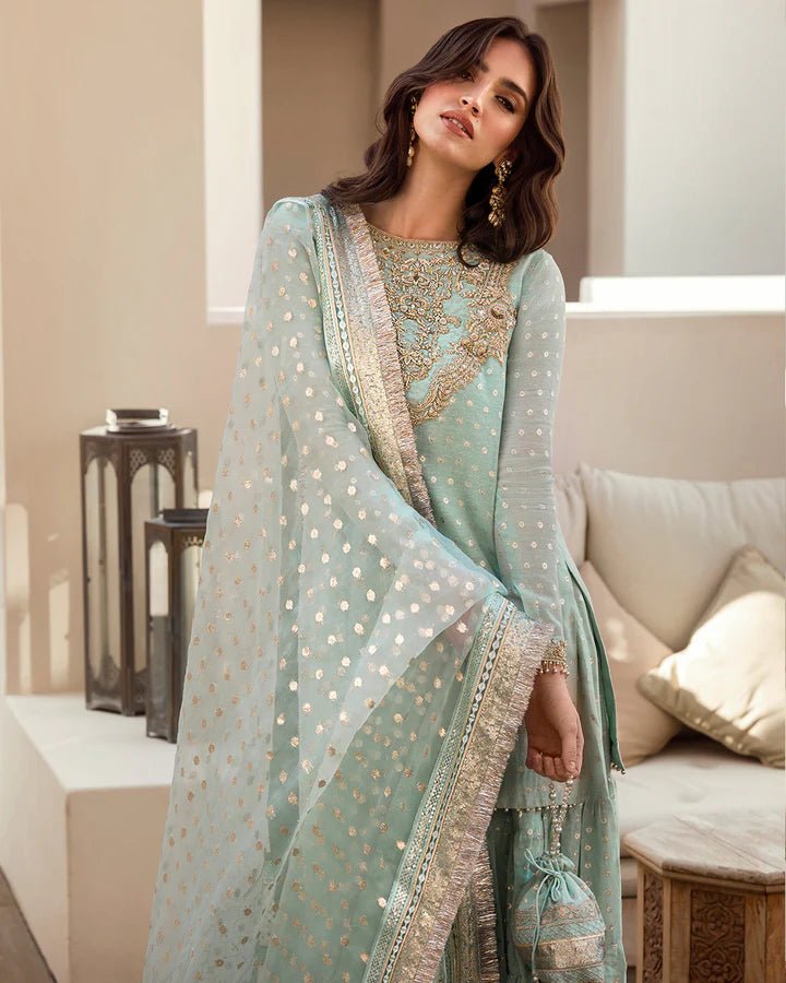 Model wearing a pastel blue Sefana dress with detailed embroidery from Faiza Saqlain's Aleira Evening Edit '24 collection. Pakistani clothes online in UK.