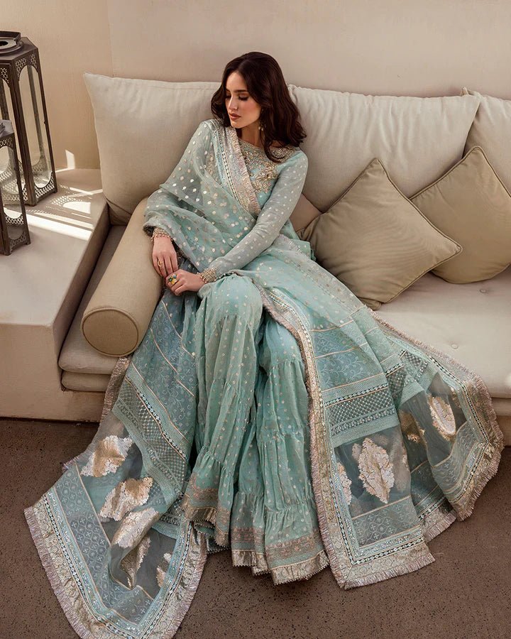Model wearing a pastel blue Sefana dress with detailed embroidery from Faiza Saqlain's Aleira Evening Edit '24 collection. Pakistani clothes online in UK.