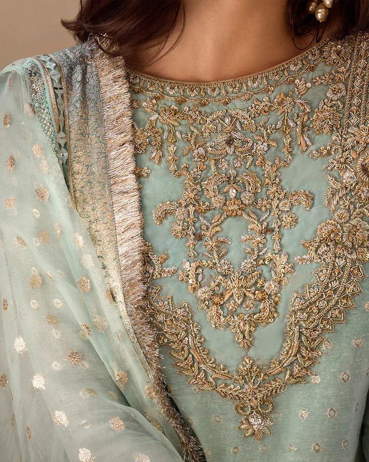 Model wearing a pastel blue Sefana dress with detailed embroidery from Faiza Saqlain's Aleira Evening Edit '24 collection. Pakistani clothes online in UK.