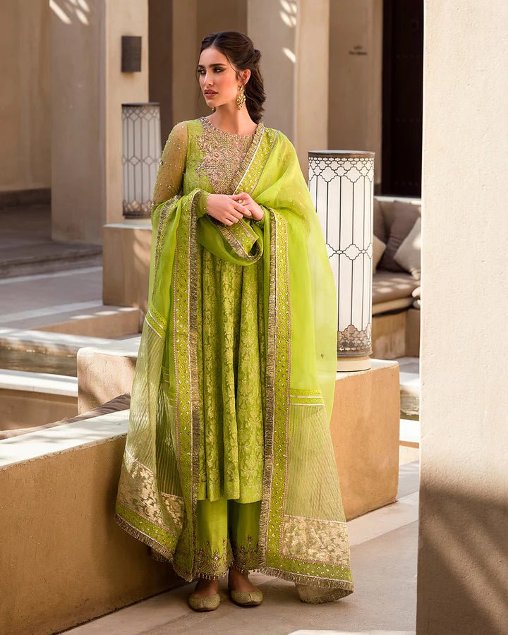 Model wearing a lime green Reya dress with intricate embellishments from Faiza Saqlain's Aleira Evening Edit '24 collection. Pakistani clothes online in UK.