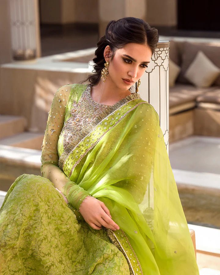 Model wearing a lime green Reya dress with intricate embellishments from Faiza Saqlain's Aleira Evening Edit '24 collection. Pakistani clothes online in UK.