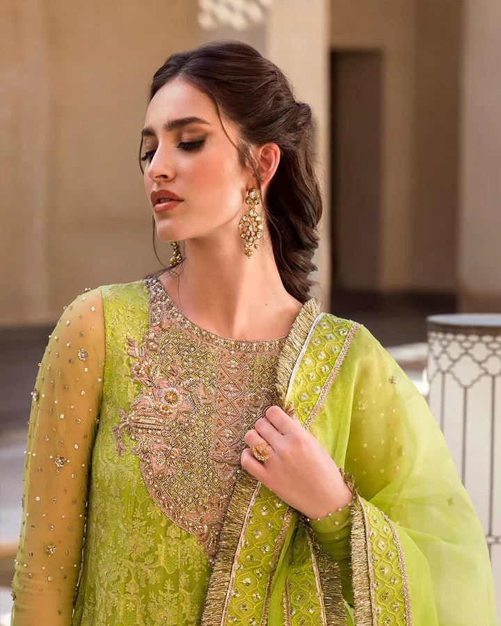 Model wearing a lime green Reya dress with intricate embellishments from Faiza Saqlain's Aleira Evening Edit '24 collection. Pakistani clothes online in UK.