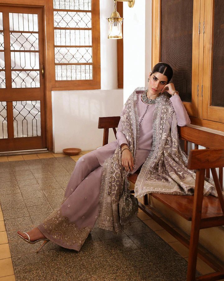 Model wearing a maroon dress with intricate silver embroidery from Faiza Saqlain's Mehermah Luxe Formals '24 collection, perfect for weddings.