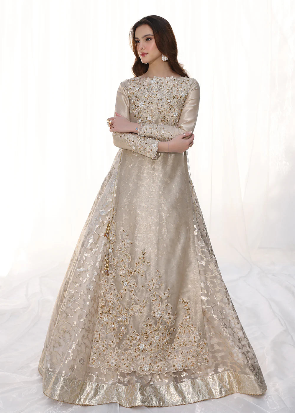 Model wearing gold embellished long dress with ruffled sleeves from Musferah Saad Golden Whispers, Pakistani Luxury pret in UK.