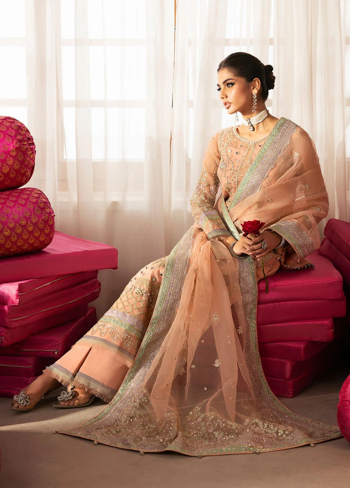 Model wearing Gulaal Raniya peach gold embroidered chiffon dress with intricate detailing and matching dupatta. Shop Pakistani clothes online in the UK now.