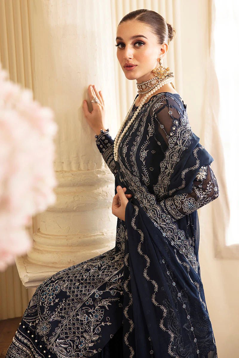 Model wearing Gulaal Embroidered Chiffon 24 Evara dress in navy blue, Pakistani wedding clothes online in UK.